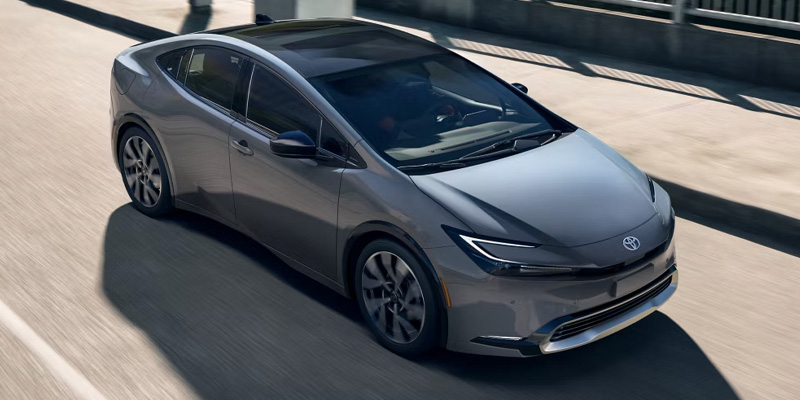 A 2025 Toyota Prius Plug-In Hybrid driving down the road in Ardmore, PA 
