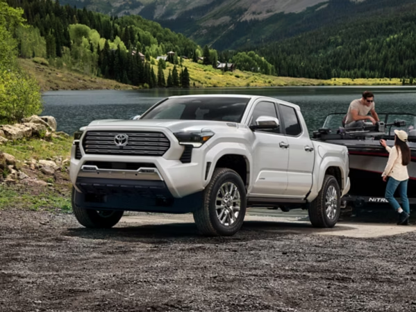 A 2026 Toyota Tacoma i-FORCE MAX backing a boat into a lake with a couple ready for a day in the water near Ardmore, PA 