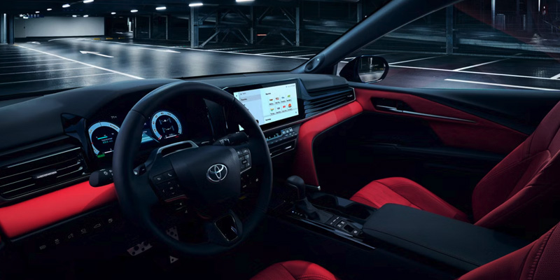 Interior of a car with a modern dashboard and red leather seats
