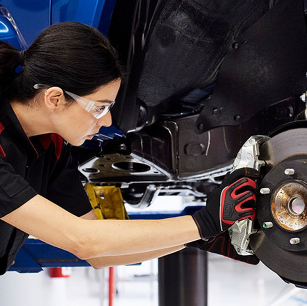 A Toyota service technician working on a Free Vehicle Repairs in conjunction with Elora J Khan Foundation in Ardmore, PA