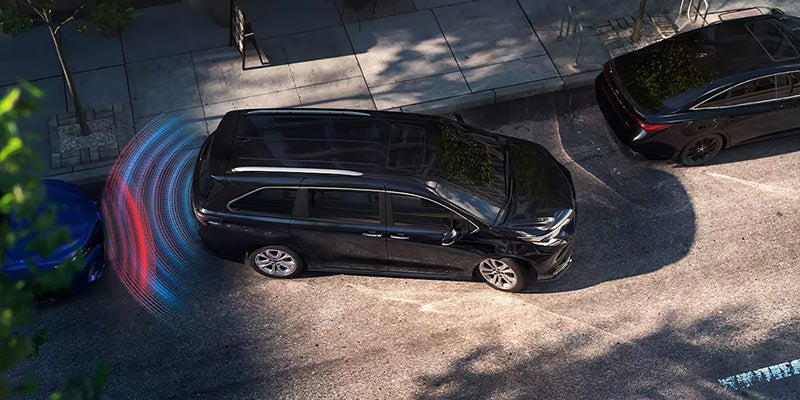 A Toyota Sienna using Toyota Safety Sense to assist with parallel parking