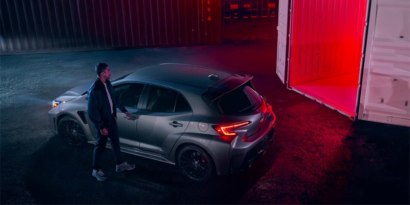 Man opening driver door for a silver 2025 Toyota GR Corolla