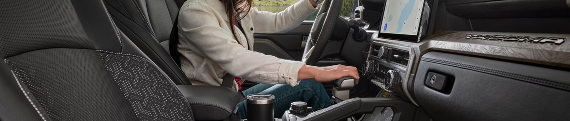 A driver using the gear shift in the 2026 Toyota Tacoma in Ardmore, PA